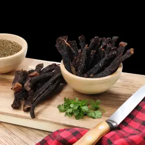Handful of traditional dry-cured beef biltong sticks at The Village Butcher, Hauraki.