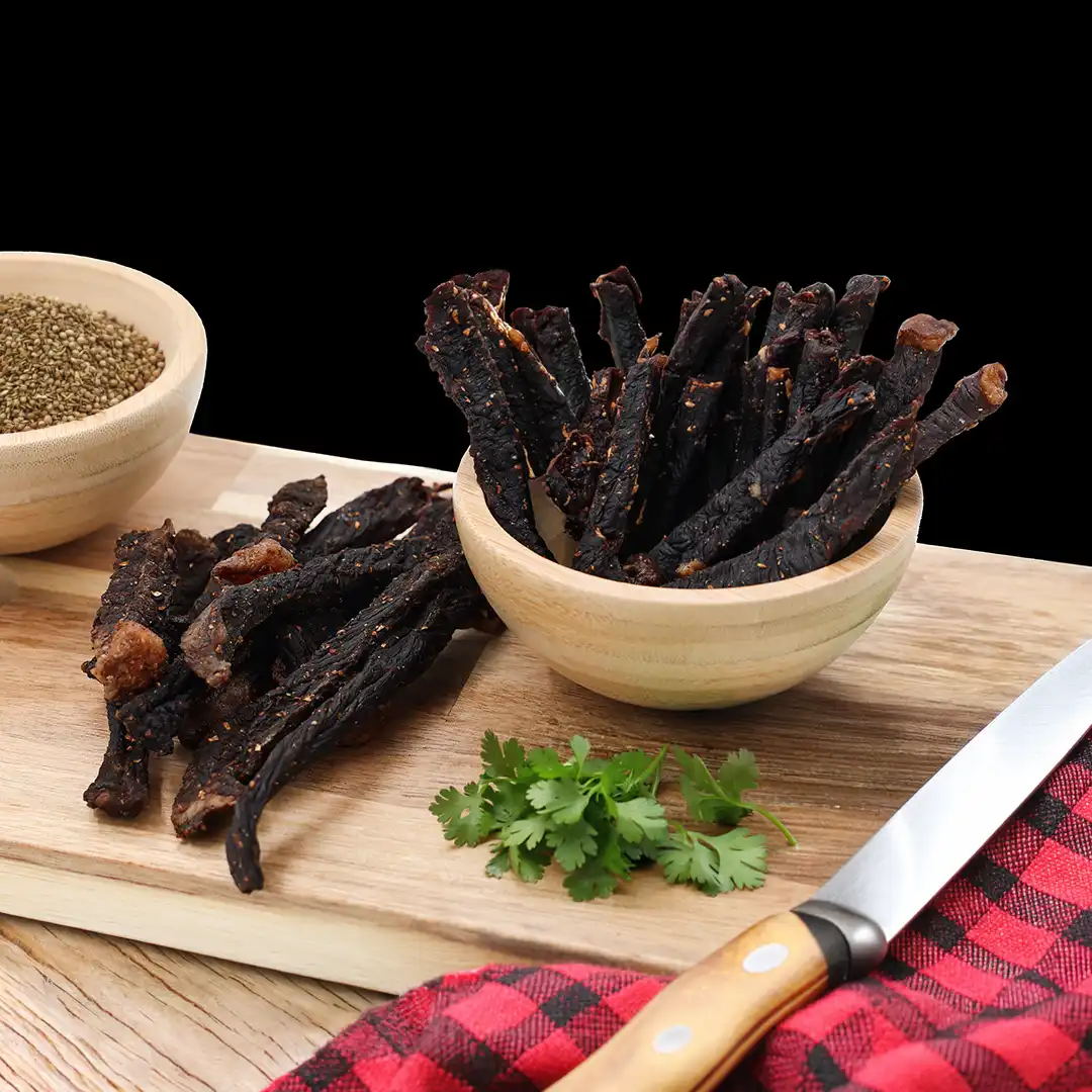 Handful of traditional dry-cured beef biltong sticks at The Village Butcher, Hauraki.