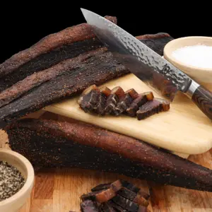 Pile of traditional sliced beef biltong seasoned with coriander and spices at The Village Butcher, Hauraki.