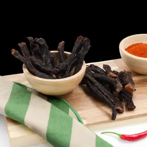 Pile of spicy dry-cured beef chilli bites (snapsticks) at The Village Butcher, Hauraki.
