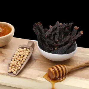 Glazed honey soy beef sticks with a dark, rich colour.