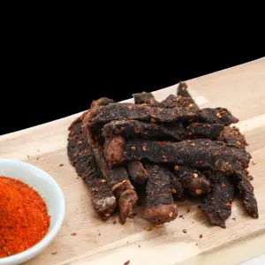 Spicy peri peri beef sticks with red spice coating at The Village Butcher.