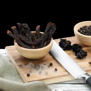 Dark, glazed smokey BBQ beef sticks piled up at The Village Butcher.